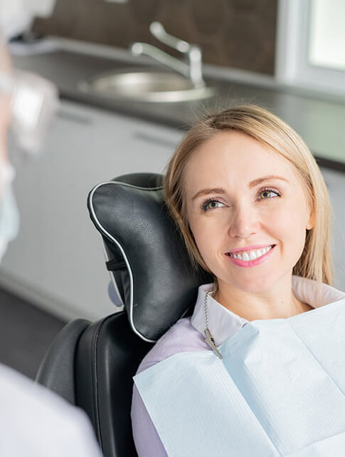 smiling woman sitting in a dental chair