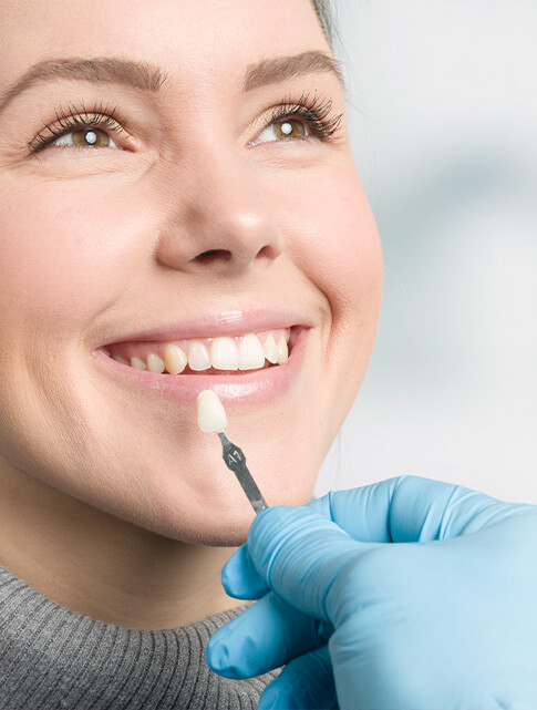 woman matching veneers to her teeth