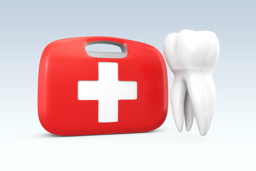 A white tooth floats next to a red and white first aid kit to indicate a dental emergency, dentist in wynne