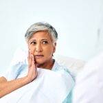 senior woman in dental chair asking how oral health and brain health are connected with gum disease linked to dementia